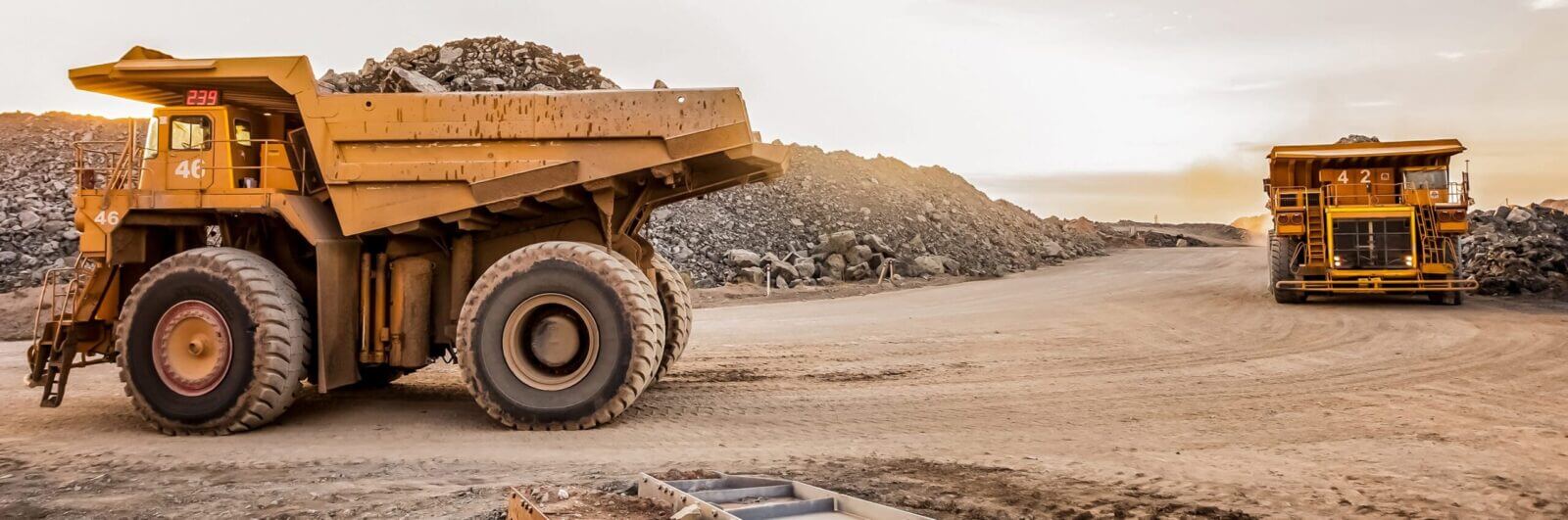 Heavy trucks at an open-pit mining operation