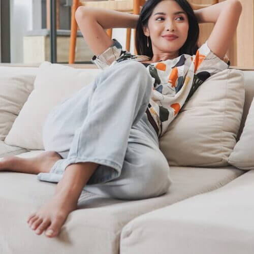 Young woman reclining on a comfortable sofa