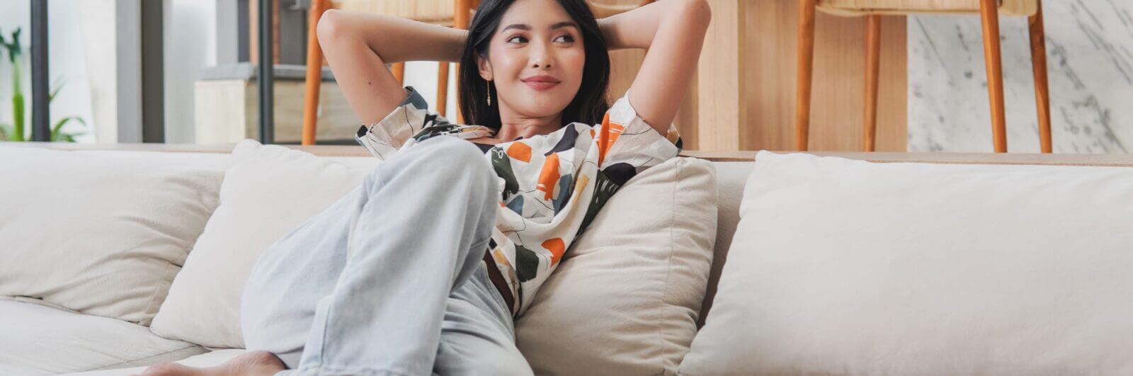 Young woman reclining on a comfortable sofa