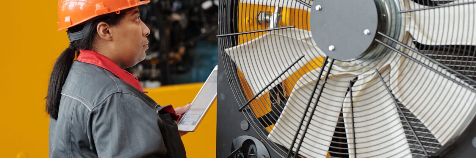 Worker inspects a large industrial fan