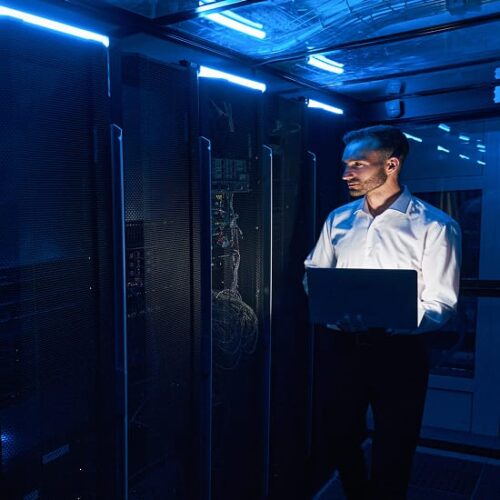 I.T. professional inspecting a server room