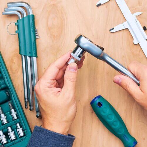 Hands holding hand tools