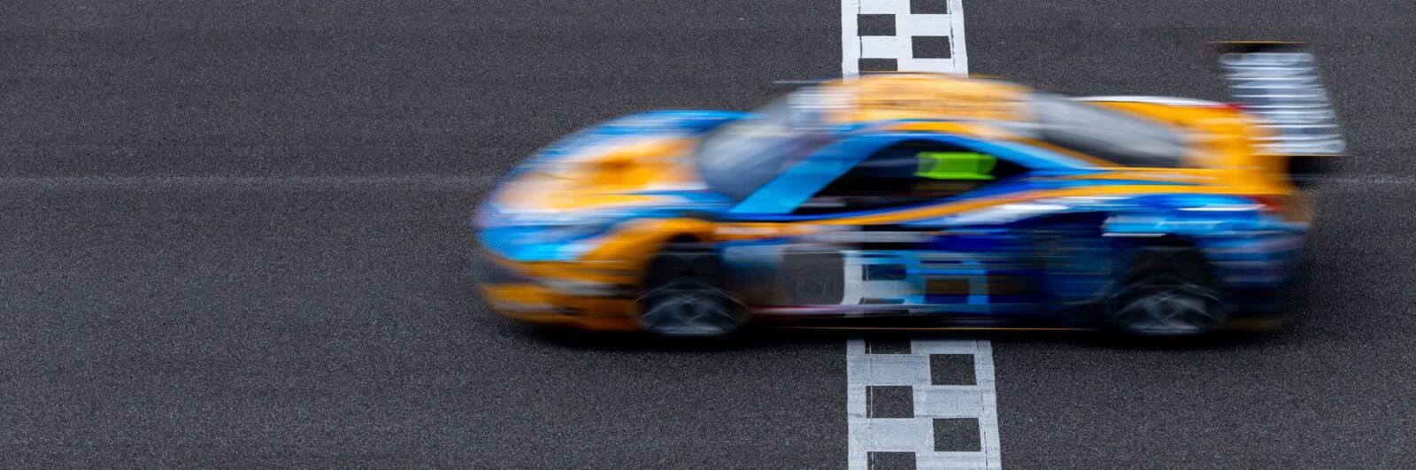 Motion blur of a race car crossing the finish line