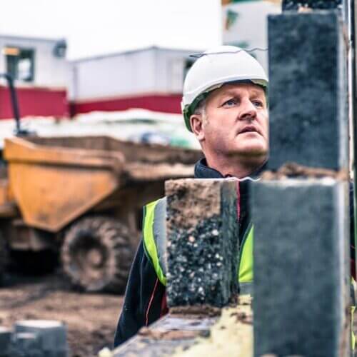 Construction worker inspecting a piling